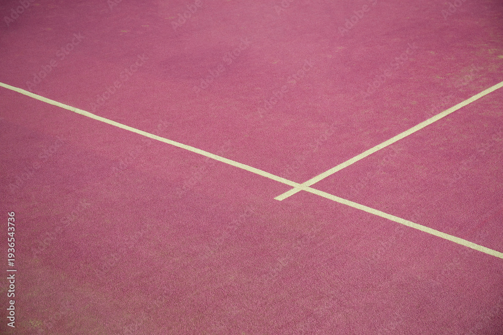 Fototapeta premium Padel court shows pink surface with white lines for play