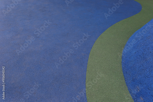 Blue and green rubber safety flooring texture for playground or sports surface background.