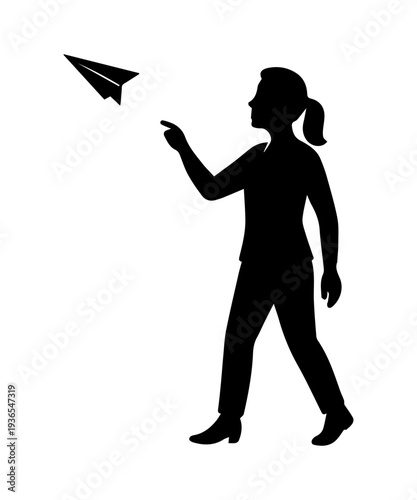 Woman silhouette launching paper plane, dreaming big