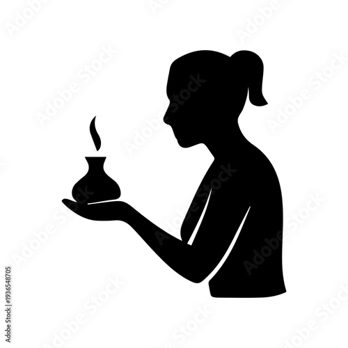 Woman holding oil burner for aromatherapy meditation