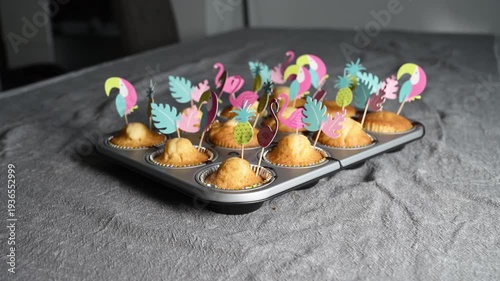 Homemade muffins on pink and grey background