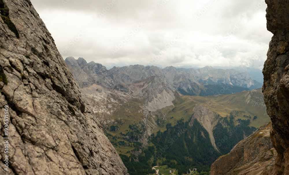 Obraz premium Alpine mountain panorama framed by limestone cliffs in Dolomites mountains Italy