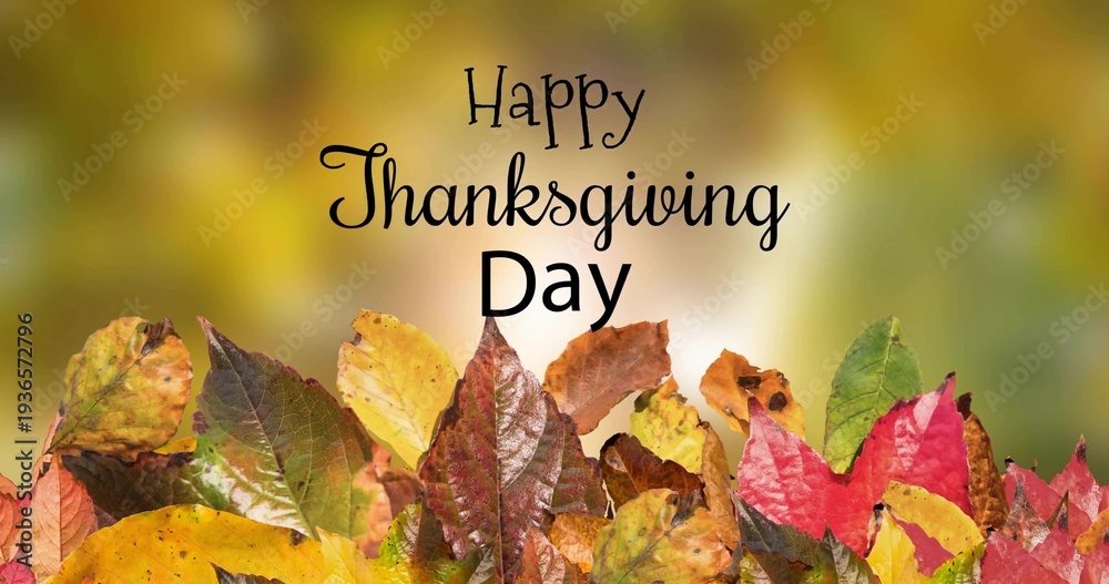 Fototapeta premium Showing autumn leaves pile with centered Happy Thanksgiving Day text on card, warm bokeh backdrop