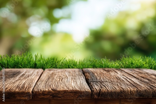 Rustic wooden table with lush green grass and blurred garden background