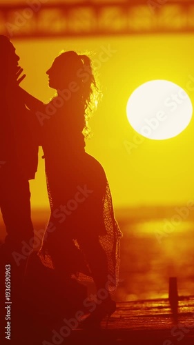 Elderly couple - dancer's silhouette with setting sun.