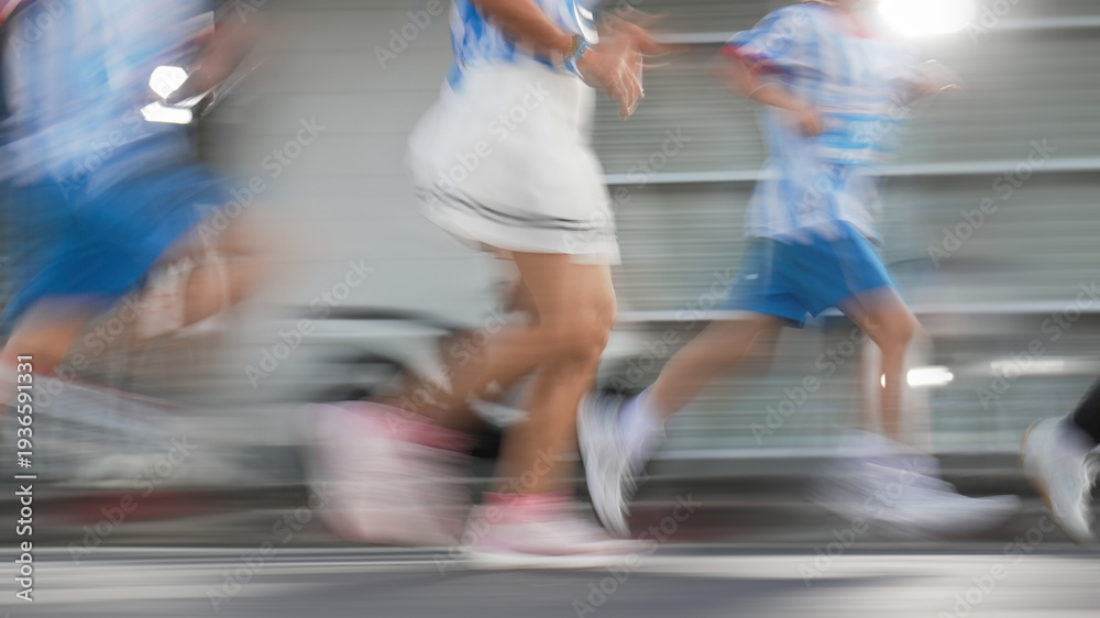 Fototapeta premium Fast-paced action shot of people running, abstract sports background