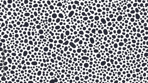 Seamless black and white pattern featuring irregular organic pebble shapes and spots reminiscent of animal prints or natural stones.
