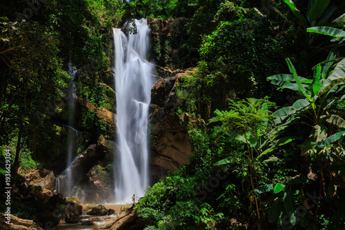 Mae taeng waterfall flowing through lush jungle in thailand