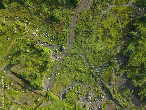 Aerial view of lush green fields and pathways intertwine, creating a vibrant tapestry of nature's beauty, Klaten Regency, Jawa Tengah, Indonesia.
