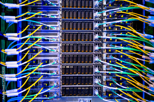 close up of server racks in a data center used for ai with cables and plugs. Concept of hardware and connectivity for AI computing center