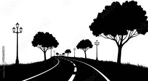 A winding road stretches through a silhouetted landscape of trees