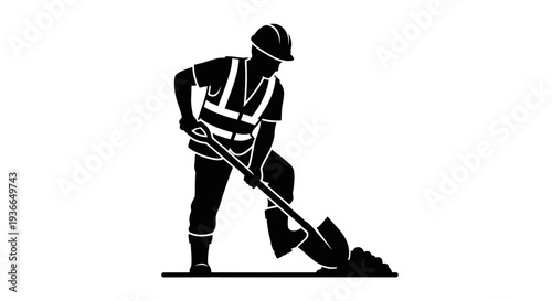 Silhouette of a construction worker digging with a shovel