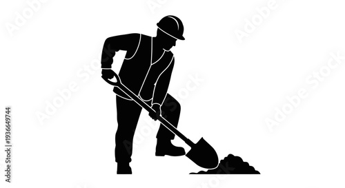 Silhouette of a construction worker digging with a shovel