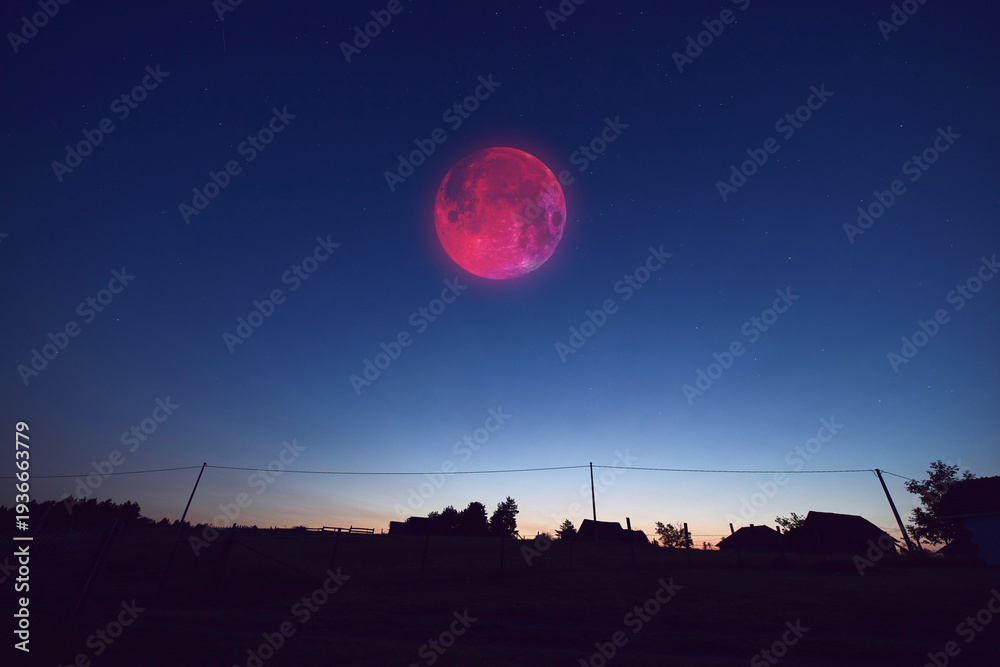 Fototapeta premium Lunar eclipse, stars and planets above landscape silhouettes.