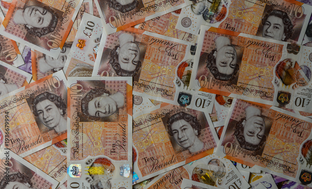 Fototapeta premium Scattered 10 Pound Sterling Notes on Table