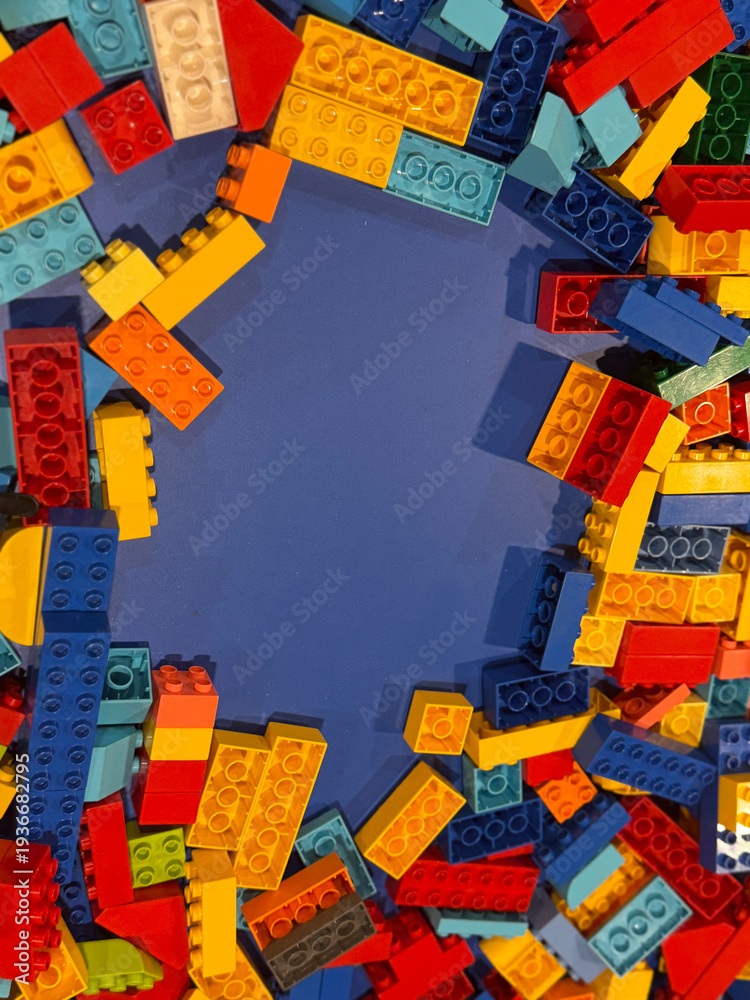 Fototapeta premium Colorful building blocks framed around blue center