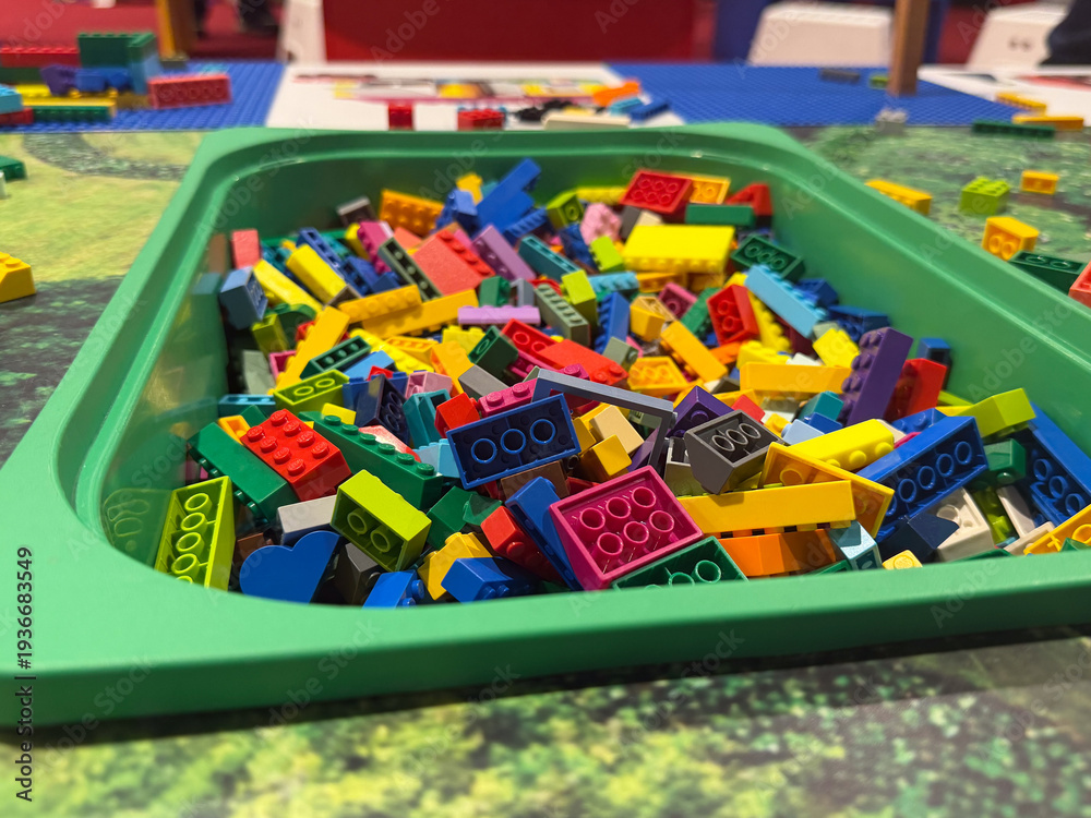 Fototapeta premium Colorful building bricks in green tray