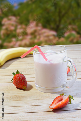 Drinking delicious natural yogurt with strawberries.
