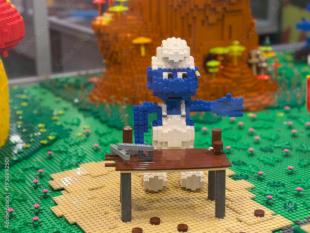 Fototapeta premium Lego blue smurf figure behind table