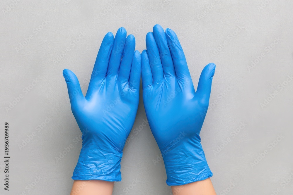 Obraz premium Hands Donning Blue Latex Gloves