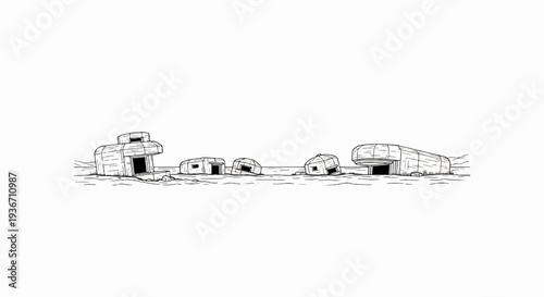 A line of weathered, concrete wartime fortifications, partially submerged in sand