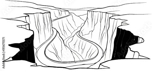 Aerial view of a winding road carved into a deep, striated canyon