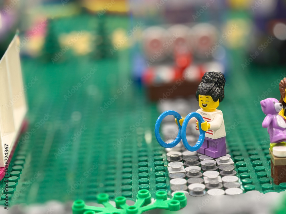 Fototapeta premium Lego minifigure playing with blue rings