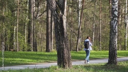 Wallpaper Mural The woman is walking through the park on a sunny summer day
 Torontodigital.ca