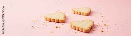 Cookies shaped like hearts on a pink surface food background banner
