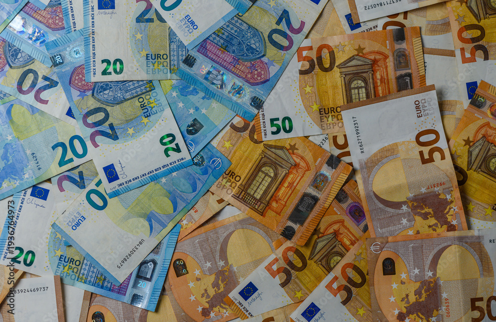 Obraz premium Closeup of Euro bills arranged on table for finance concept