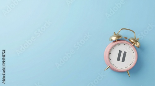 Pink Alarm Clock with Pause Symbol on Blue Background