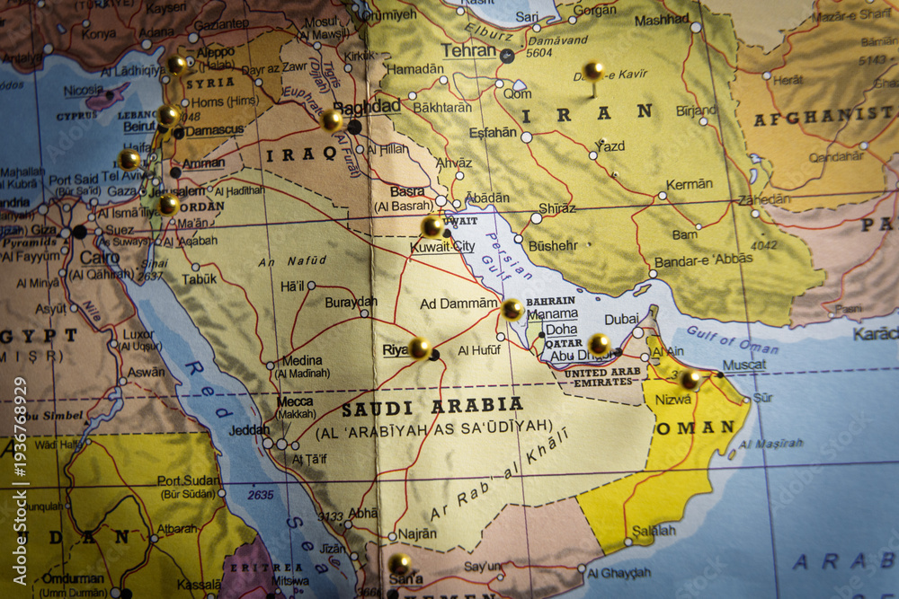 Fototapeta premium Middle East political map with gold push pins marking major cities in Iran, Iraq, and Saudi Arabia, geopolitical strategy and travel planning concept