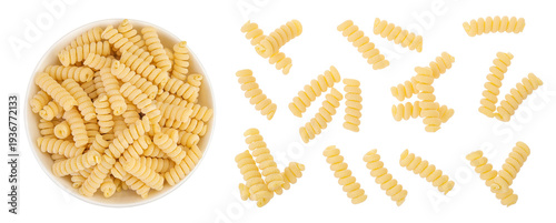Italian spiral shaped pasta, Fusilli bucati macaroni in ceramic bowl, isolated on white background. Top view. Flat lay.