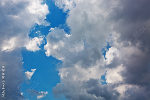 Gray rain clouds and blue sky in summer day.