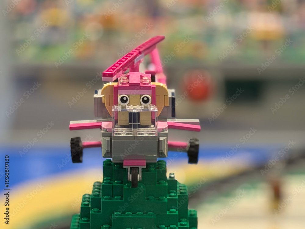 Fototapeta premium Pink brick airplane on green stand