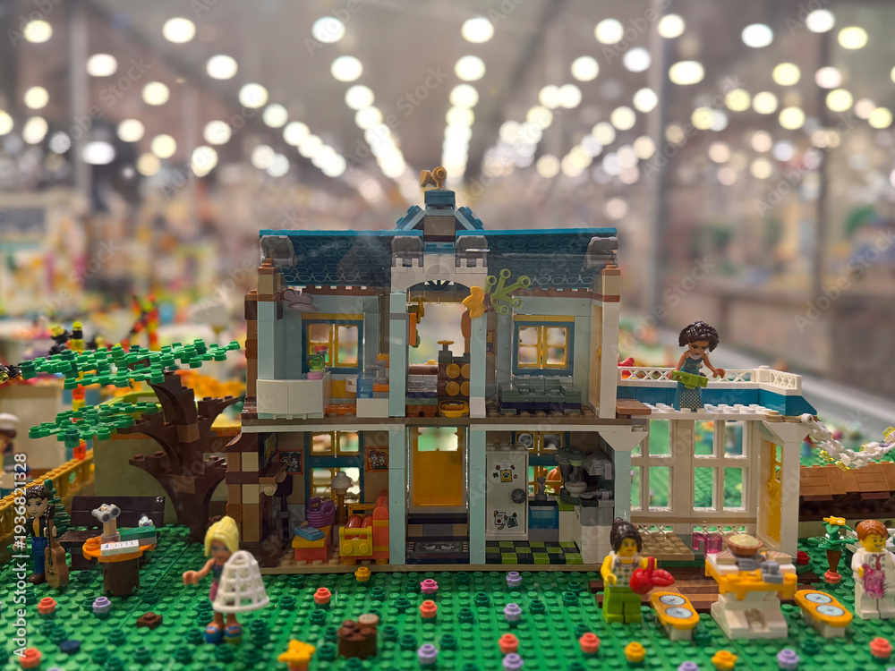 Fototapeta premium Colorful two-story lego house with garden and minifigures