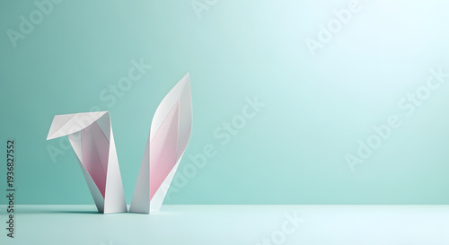 Pink paper bunny ears on teal background