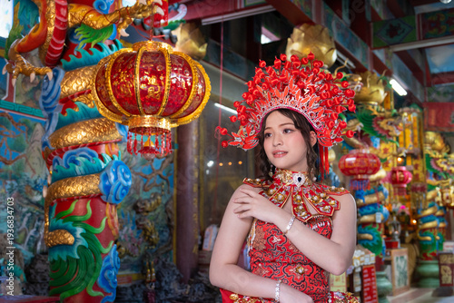 Slika na platnu Young woman traditional red dress and elaborate headdress posing inside colorful