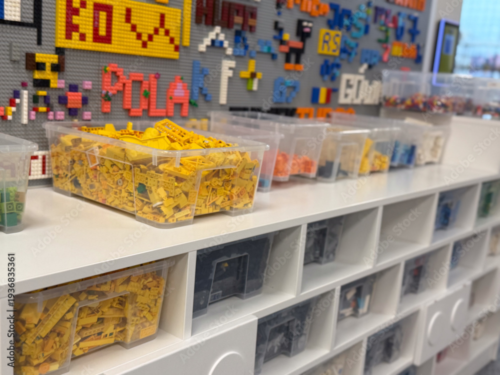 Fototapeta premium Organized lego bins on white shelving