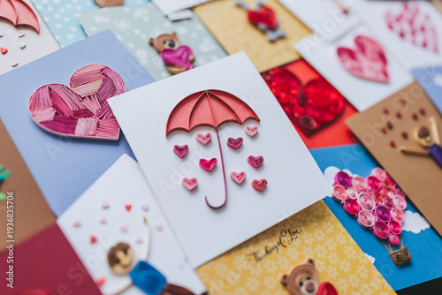 A collection of colorful, handmade cards showcasing various designs for anniversaries and birthdays. Hand made of paper quilling technique. Handicraft at home. Hobby, home office. Cute paper cards 