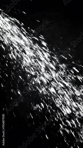 Abstract black and white image depicting a chaotic flurry of light particles against a dark background evoking a sense of movement energy and digital disruption
