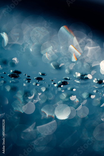 Abstract water drops background with rainbow lens flare and bokeh