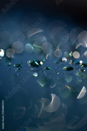 Abstract blue background with water drops and soft bokeh lights