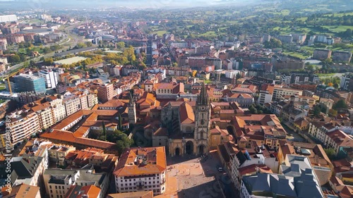High altitude aerial view of Oviedo city center and Cathedral, bird's eye perspective of red terracotta roofs and historic town square, Asturias, Spain, 4K drone