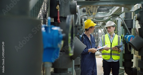 Εκτύπωση καμβά Professional engineer is inspecting industrial machinery valves in a modern plant, focusing on operational efficiency, quality control, and industrial safety compliance