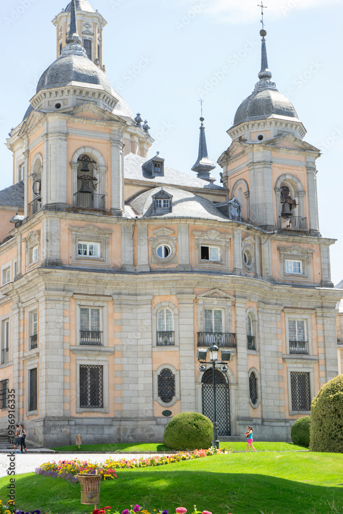 Fototapeta premium Historic building with towers and colorful flowers.. Royal Palace of La Granja de San Ildefonso, Spain