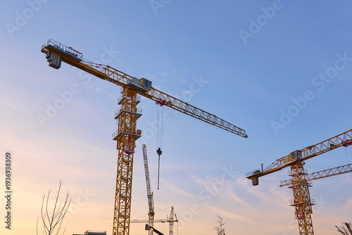 tower cranes are working at the construction site