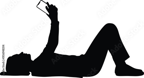 Black silhouette of a person lying down on their back holding a smartphone and looking at the screen against white.