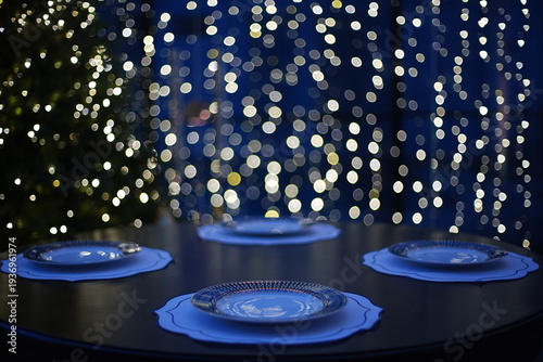 a table set with luxurious dishes against a backdrop of tiny lights