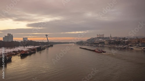 Bratislava Old Town and SNP Bridge over Danube River at sunset time lapse, Slovakia.